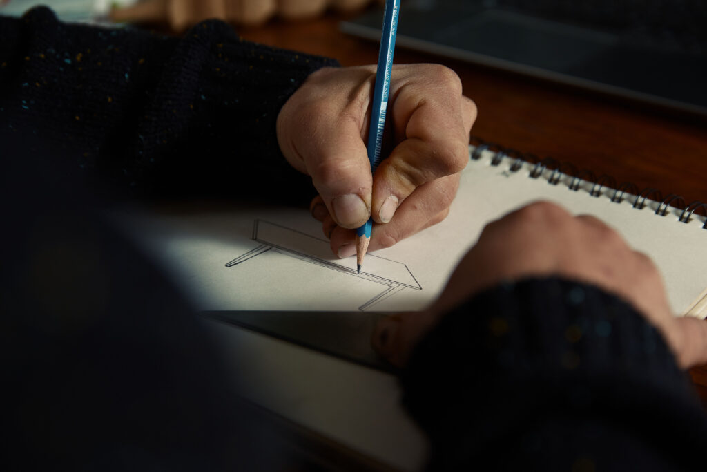 close up of hands making furinture drawings
